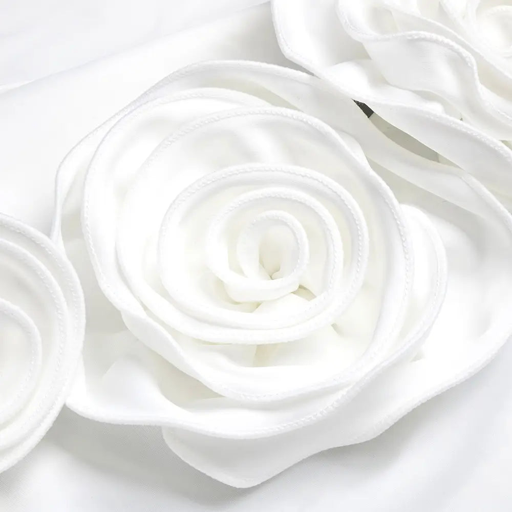 a white fabric rose with layered soft petals and a smooth satin-like finish adorns the style white ribbon flower on the satin white ribbon flower halter gown.