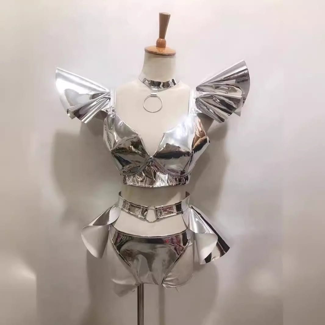 Shiny silver metallic two-piece stage costume sexy with reflective pleated fabric and structured design in a costume sexy bright hard style