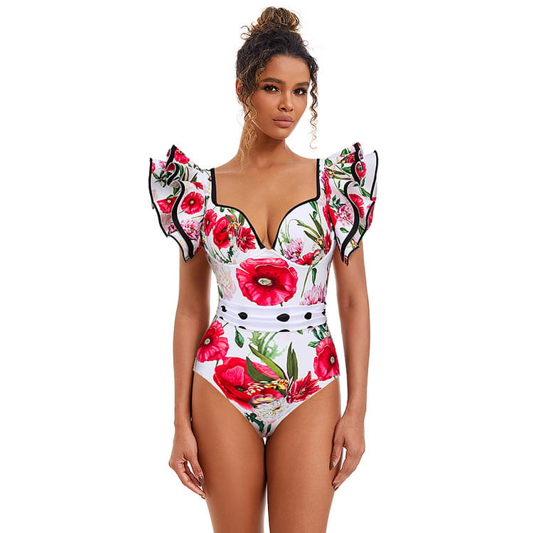 White chiffon polyester printed one-piece swimsuit featuring a vibrant red poppy floral print with black trim along the neckline and ruffled sleeves.