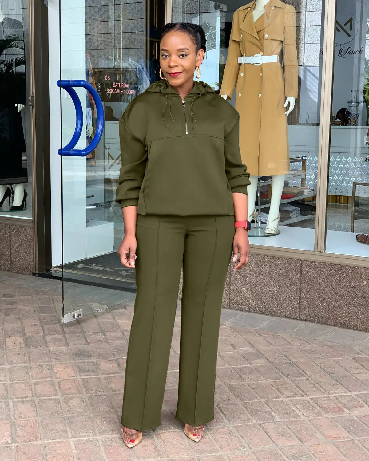 Olive green solid color loose hooded sweatshirt with front zipper and long sleeves designed for comfort and casual wear.