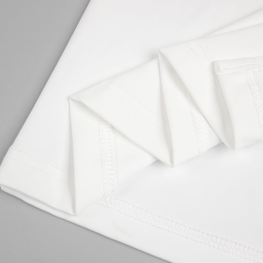 white cotton pillowcase with delicate embroidered trim paired with satin white ribbon flower halter gown showcasing style white ribbon detail
