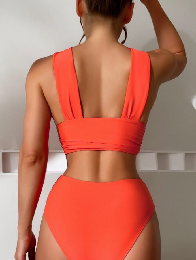 a vibrant orange two-piece solid colour swimsuit with a high-waisted bottom and a cropped top featuring wide shoulder straps, suitable as an alternative to the royal blue cross halterneck pleated swimsuit.