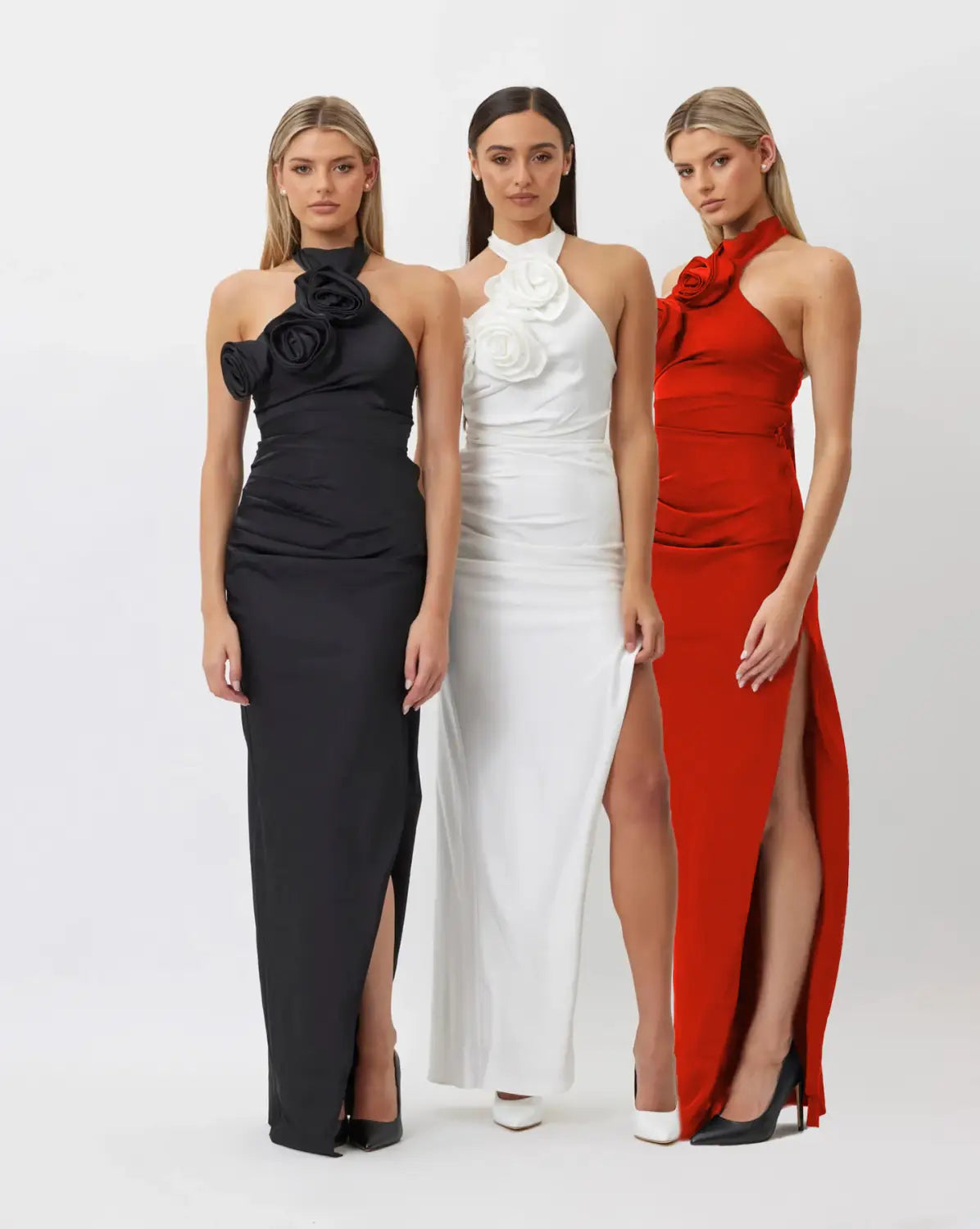 elegant satin halter-neck gowns in black white and red featuring a prominent white ribbon flower embellishment at the neckline highlighting style white ribbon and ribbon flower halter design.