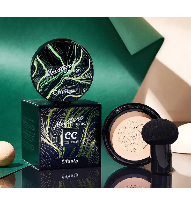 Ivory marbled air cushion foundation with a black sponge applicator in a black and green marbled moisture cushion cream foundation compact.