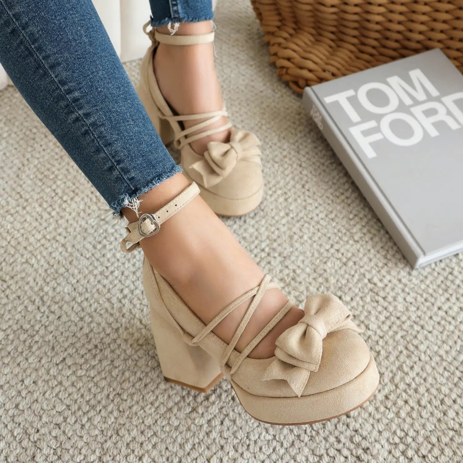 Beige suede platform lolita heels featuring an ankle strap and a small size bow on the toe.