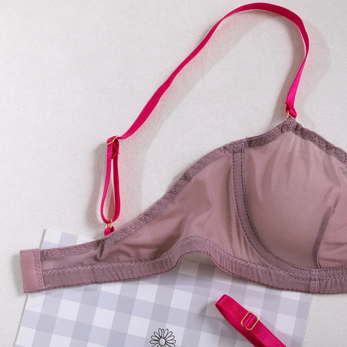 A mauve see-through two-piece set featuring a wire-free bra with bright pink straps made of comfortable sheer mesh fabric.