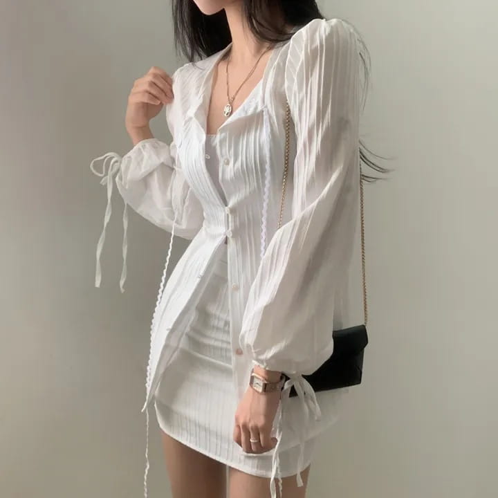 White ribbed long sleeve shirt dress with sheer fabric, puffy sleeves, and tie waist detail.