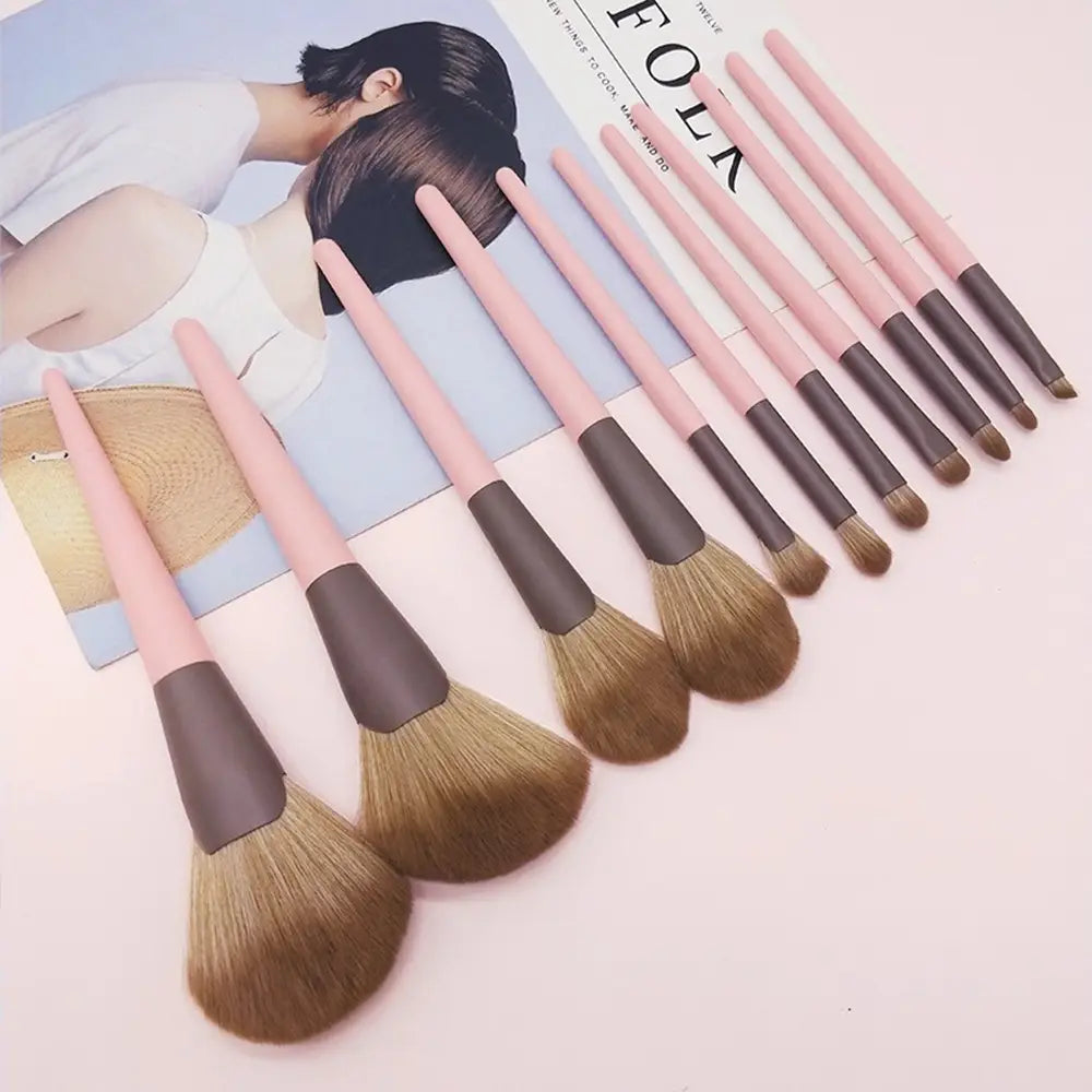 Set of ten pink and brown-handled makeup brushes with soft natural-looking bristles included in the 11 piece premium pink and black makeup brush set.