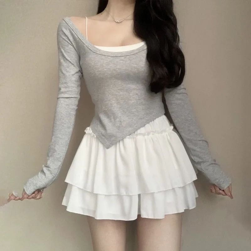 gray long-sleeved off-the-shoulder top paired with a white ruffled pettiskirt layered underneath showcasing the pure desire style pettiskirt slimming ballet skirt.