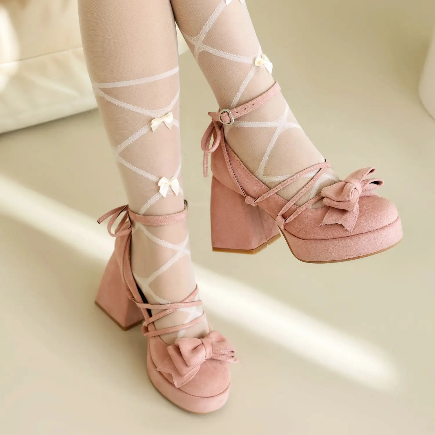 Pink platform lolita heels with lace-up straps and decorative small size bow accents.