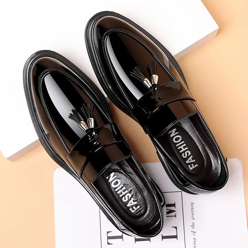 black patent leather tassel loafers with a glossy finish and metallic silver accents on the tassels designed for business formal wear leather shoes