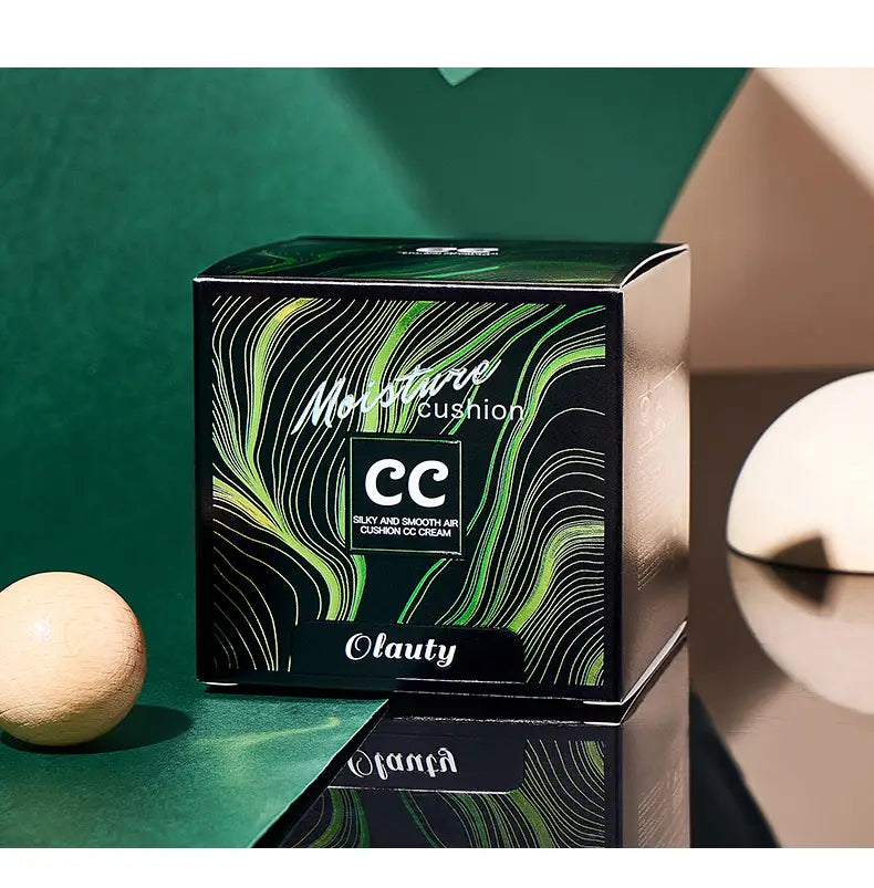 Black and green patterned box for Olauty’s silky and smooth Ivory Marbled air cushion foundation with sponge featuring a cream foundation air cushion design.