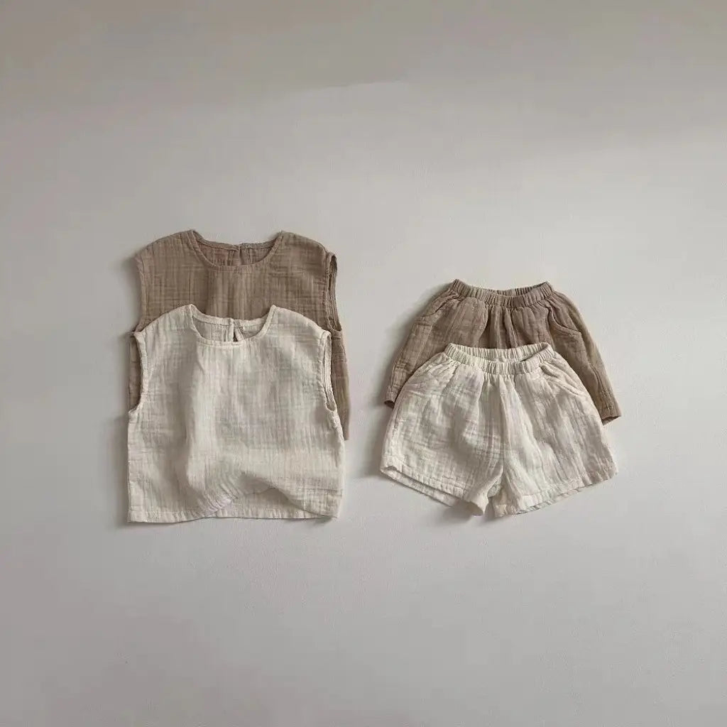 a pair of soft textured linen breathable vest shorts set in neutral beige and off-white tones made from cotton muslin for comfortable wear