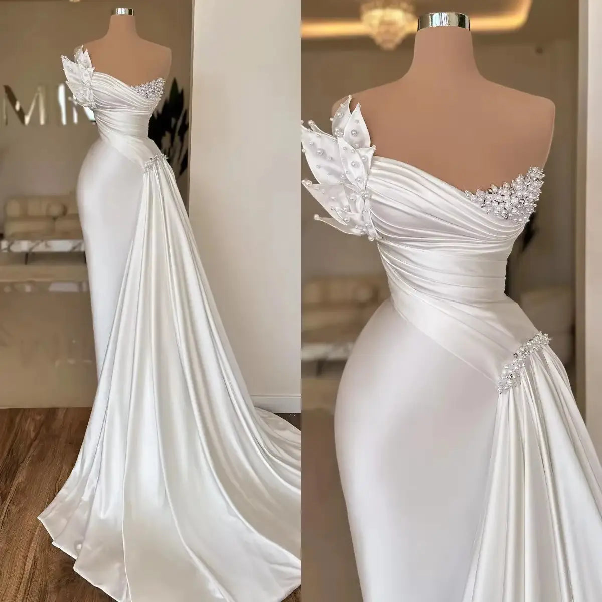 A white graceful satin off-the-shoulder wedding dress featuring sparkling beaded embellishments and a flowing train with a simple lightweight satin design.