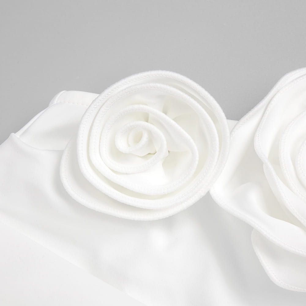 white fabric rose accessory with soft layered petals on a satin white ribbon flower halter gown showcasing elegant style white ribbon detail