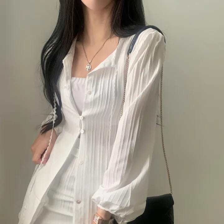 white pleated long sleeve button-up shirt made of ribbed fabric featured as part of a white ribbed long sleeve shirt dress with tie waist collection