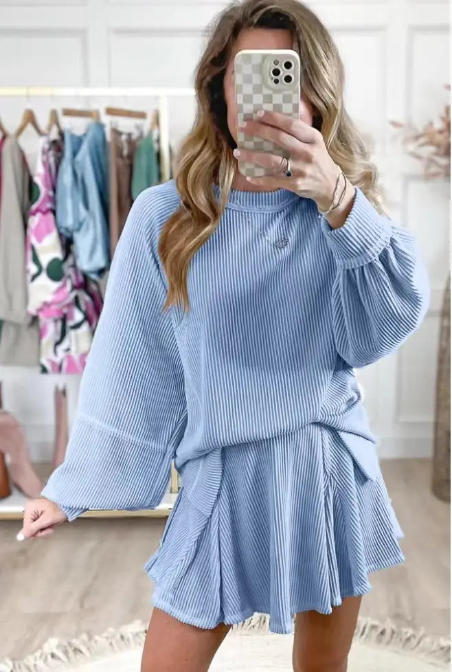 light blue corduroy women’s solid colour casual suit featuring a high neckline, long balloon sleeves, and a flared skirt tied at the waist.