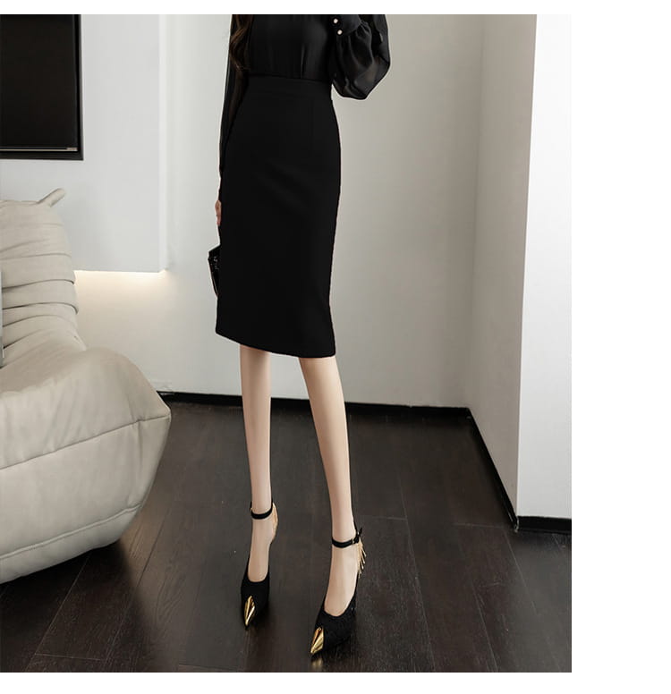 Black satin midi line sheath skirt with a sleek form-fitting silhouette and subtle side seam detailing for an elegant tight fit.
