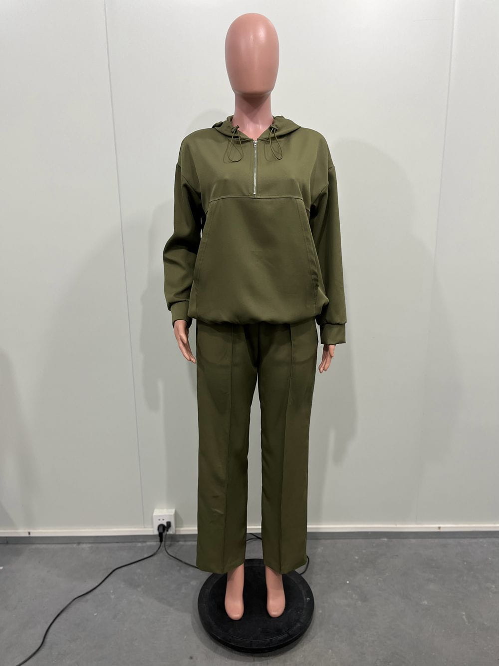 olive green solid color loose hooded sweatsuit set featuring a hooded sweatshirt and matching trousers in a comfortable relaxed fit