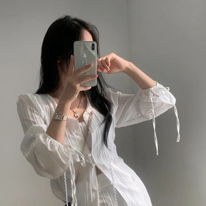 white ribbed long sleeve shirt dress featuring a sheer button-up long sleeve shirt with ruffled sleeves and tie-back details shown from the back.