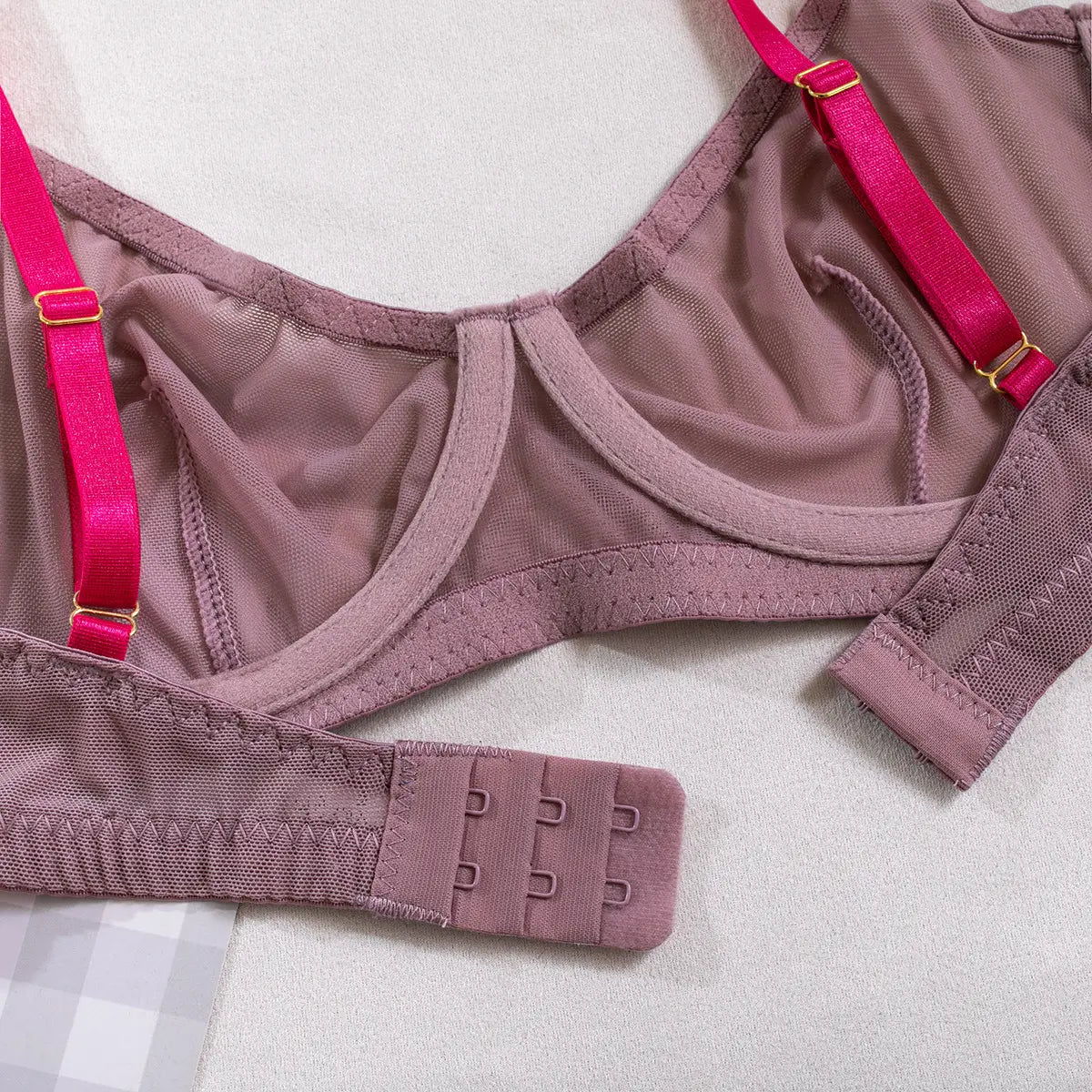 A mauve-colored bra with pink satin straps and gold-toned hardware featuring a mesh fabric design from the lavender and pink see-through two-piece set made with comfortable fabric.