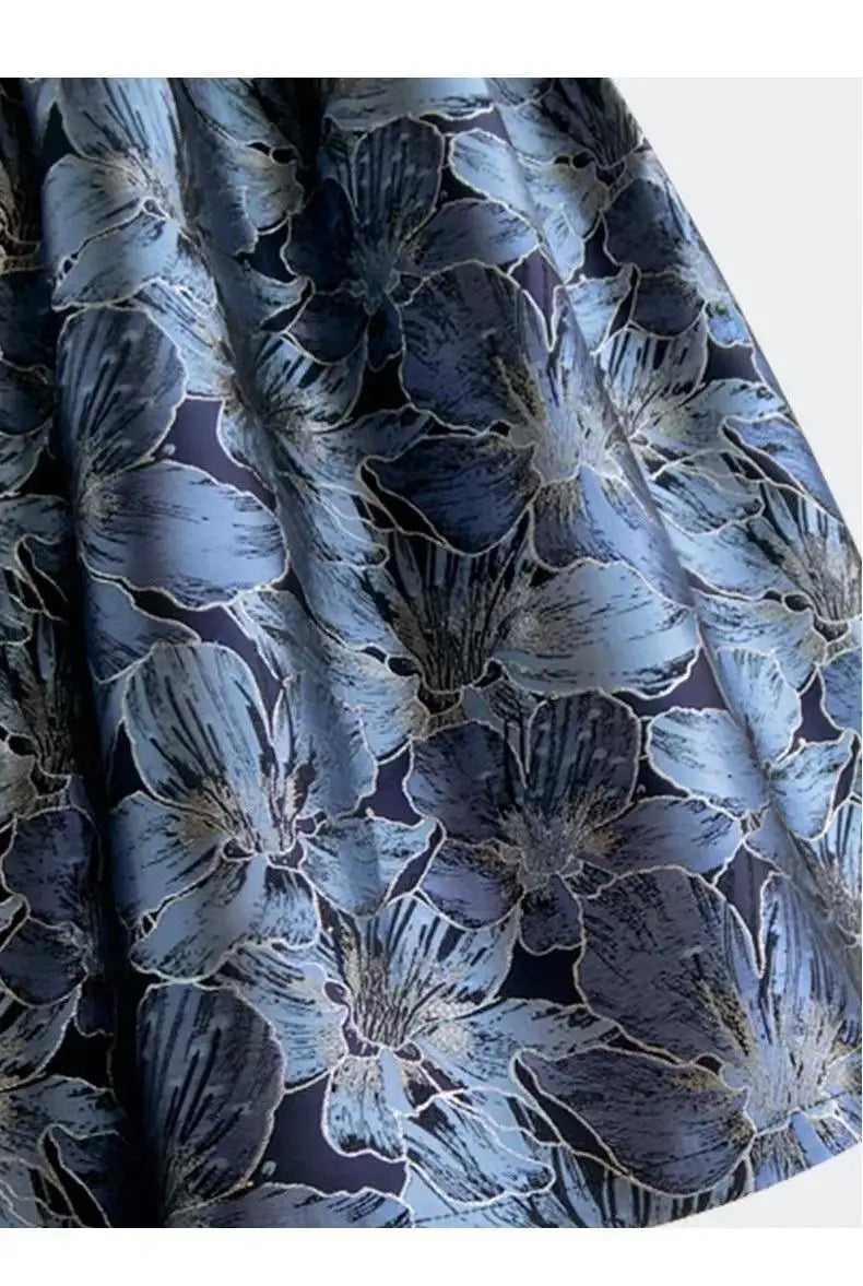 A navy blue high waist slimming jacquard midi skirt featuring a flowing floral pattern in lighter shades of blue and silver.
