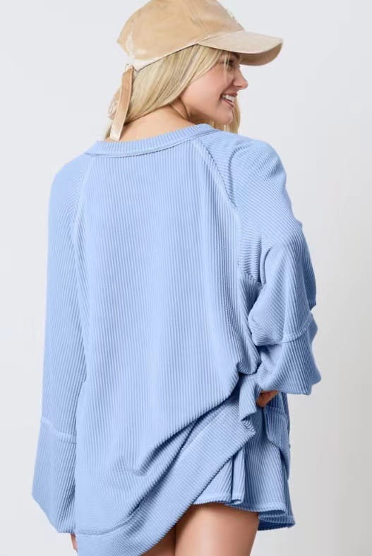 Light blue solid colour casual suit featuring a women’s ribbed knit oversized sweater with ruffled sleeves and a relaxed fit.