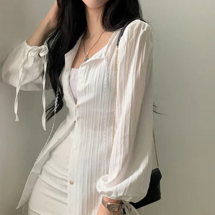 white ribbed long sleeve shirt dress featuring puffed sleeves and tie-back details made from ribbed fabric