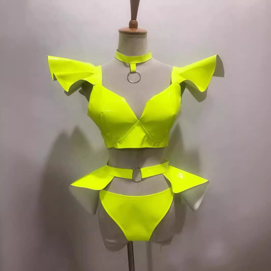neon yellow stage costume sexy patent leather two-piece outfit with ruffled shoulder straps and a matching belt reflecting a costume sexy bright look