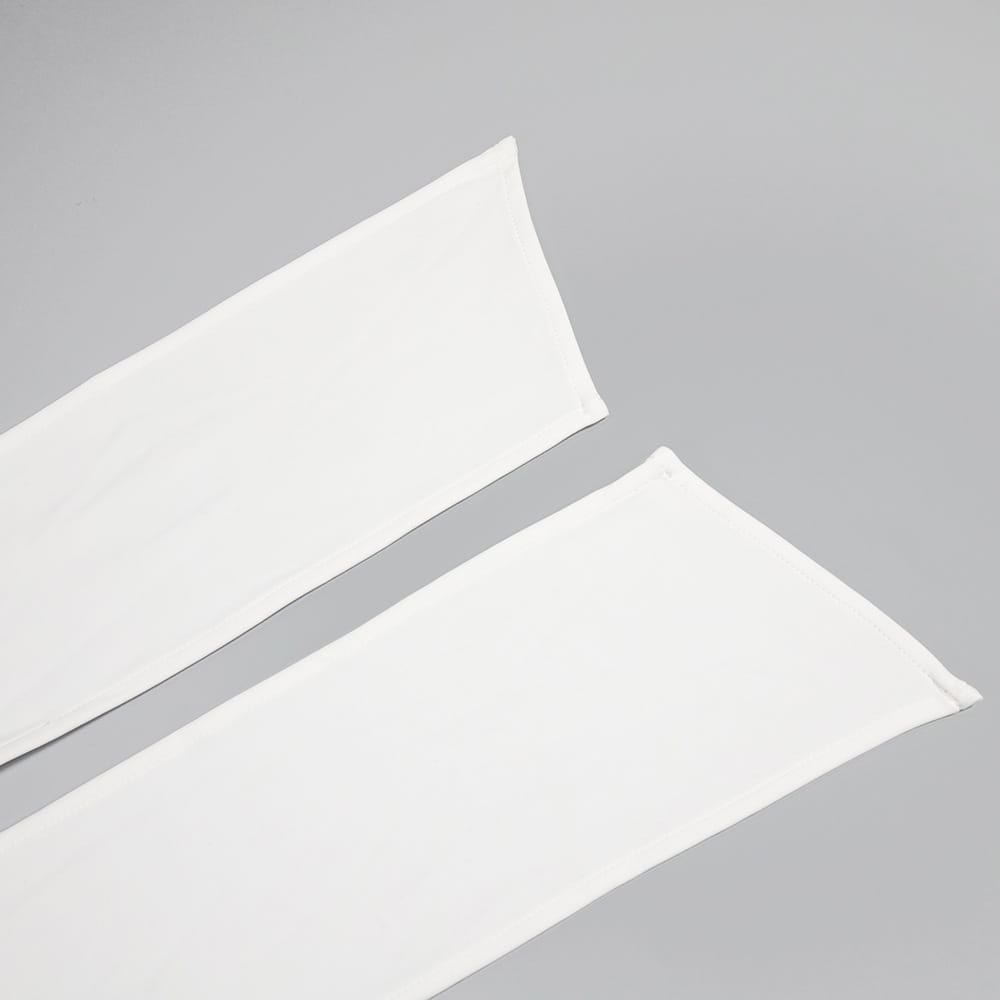 two white smooth-textured fabric arm warmers laid flat complement the style white ribbon satin white ribbon flower halter gown