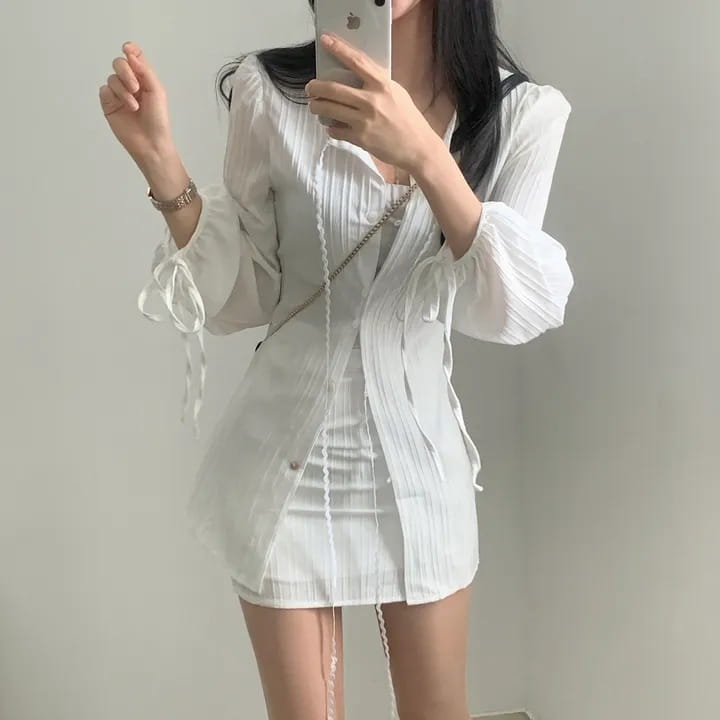 white ribbed long sleeve shirt dress featuring pleated design with tie cuffs and front button closure