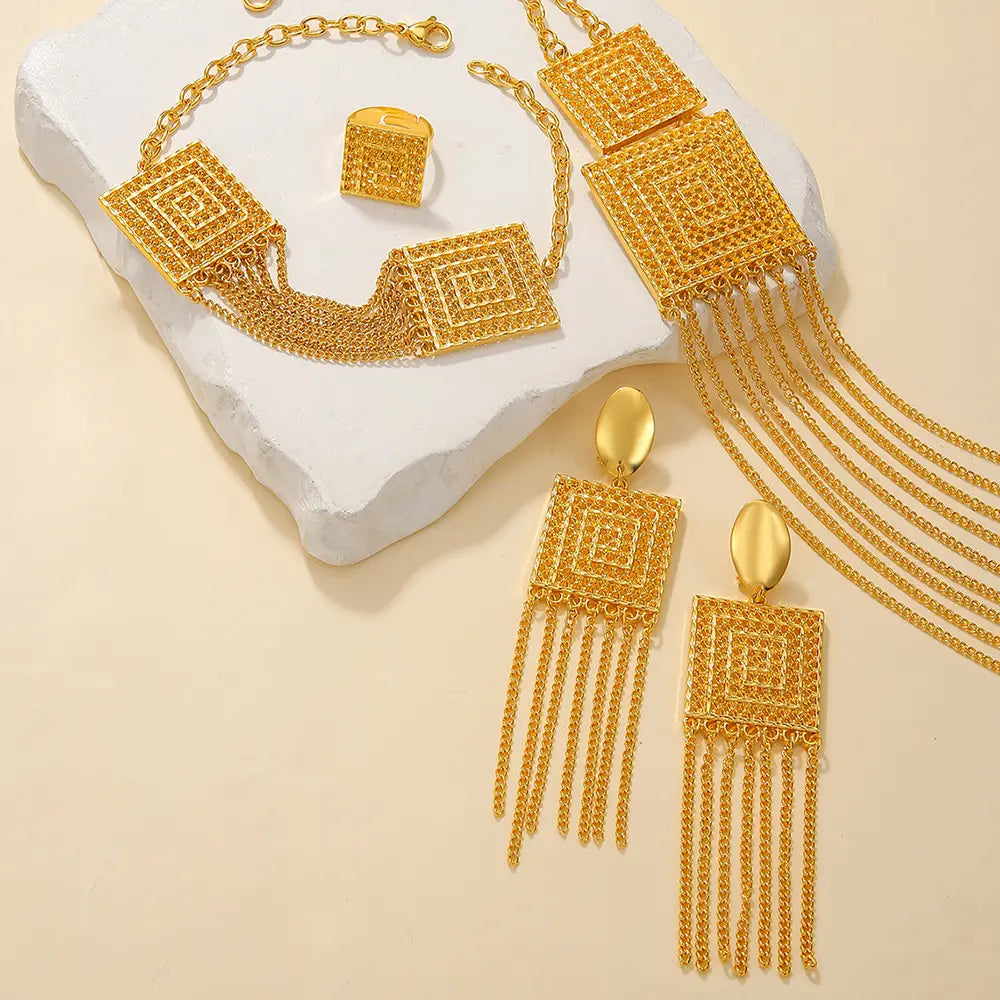 gold plated 5pcs fashion ladies jewelry set featuring a gold toned geometric necklace with intricate square designs and dangling chain fringe in fashion ladies 18k style.