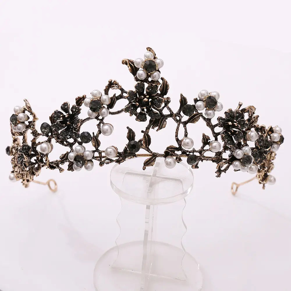 An ornate floral black diamond pearl baroque bridal crown in black and silver featuring intricate floral designs adorned with pearls and dark gemstones.