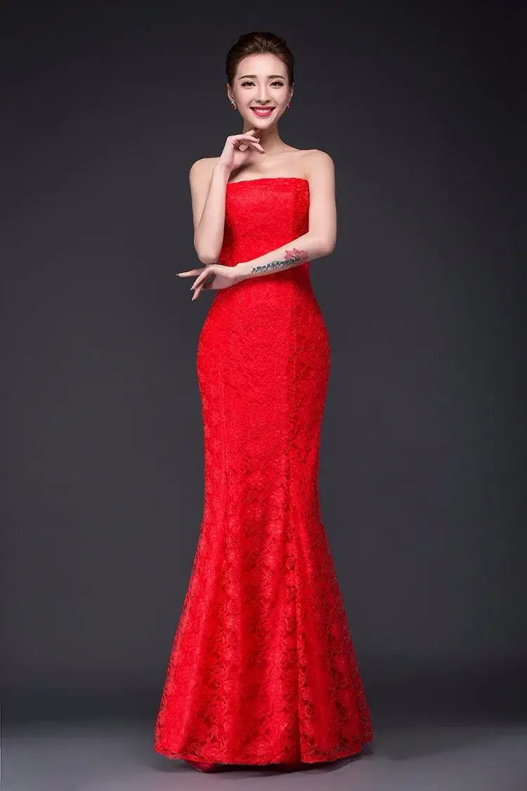 A vibrant red strapless lace mermaid wedding dress featuring intricate detailing in a long dress fuchsia style.
