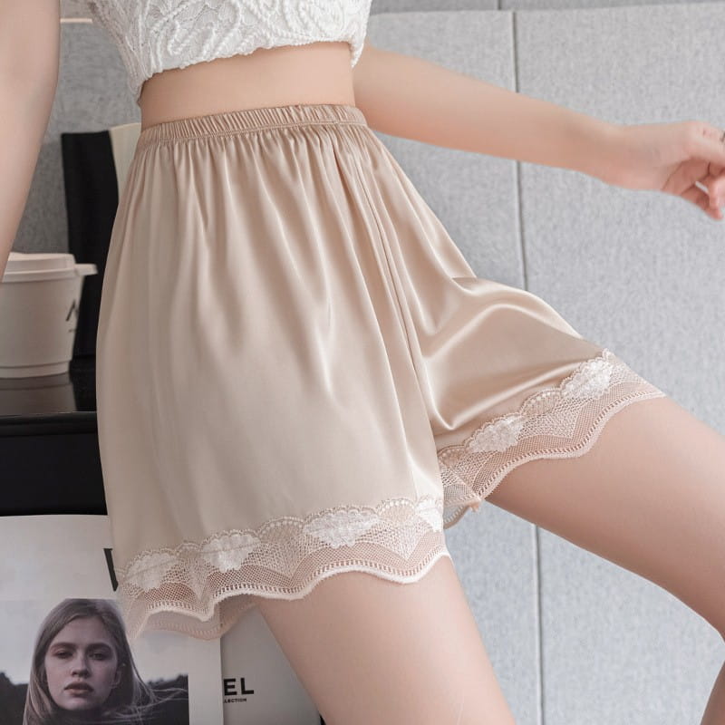 beige satin ice silk seamless shorts with delicate white lace trim along the hem in a pink ice silk seamless lace trim shorts design