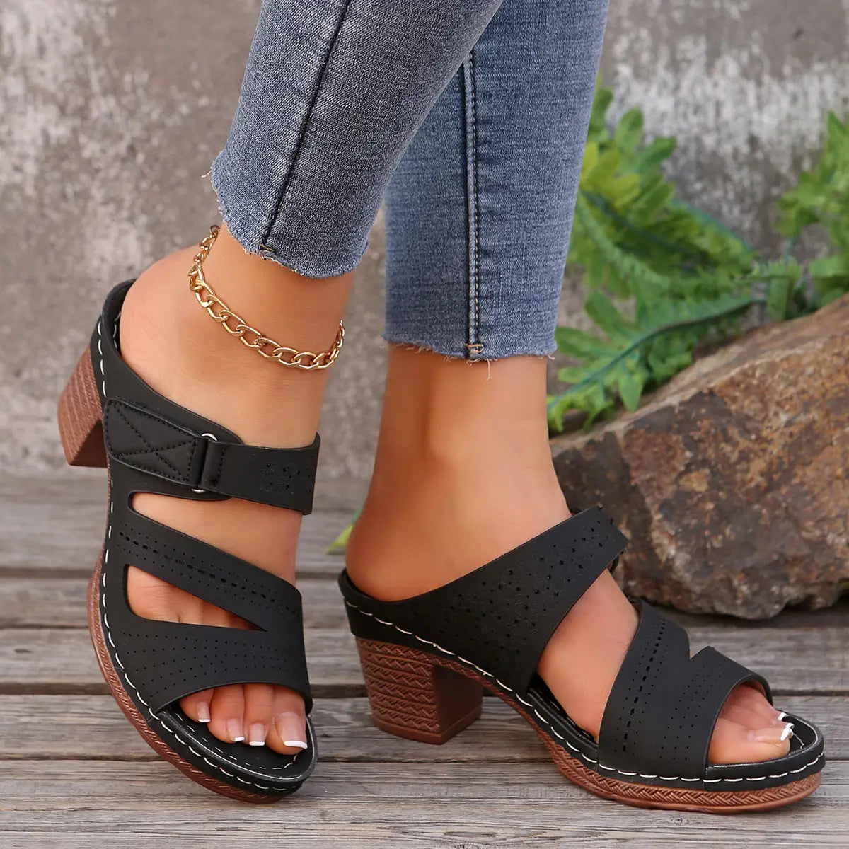 black perforated leather strap sandals with brown textured block heel and white stitching designed as summer casual chunky shoes summer casual