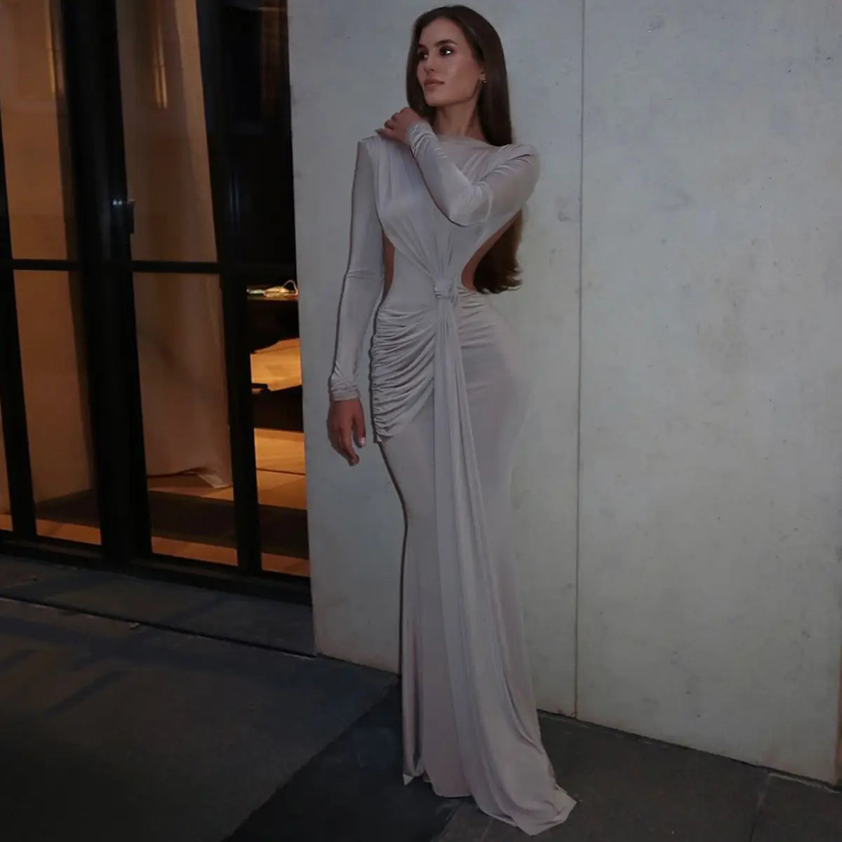 A sleek silver-gray long sleeve dress with a ruched side panel and an open back designed as a sexy hot girl hollow out long sleeve dress.