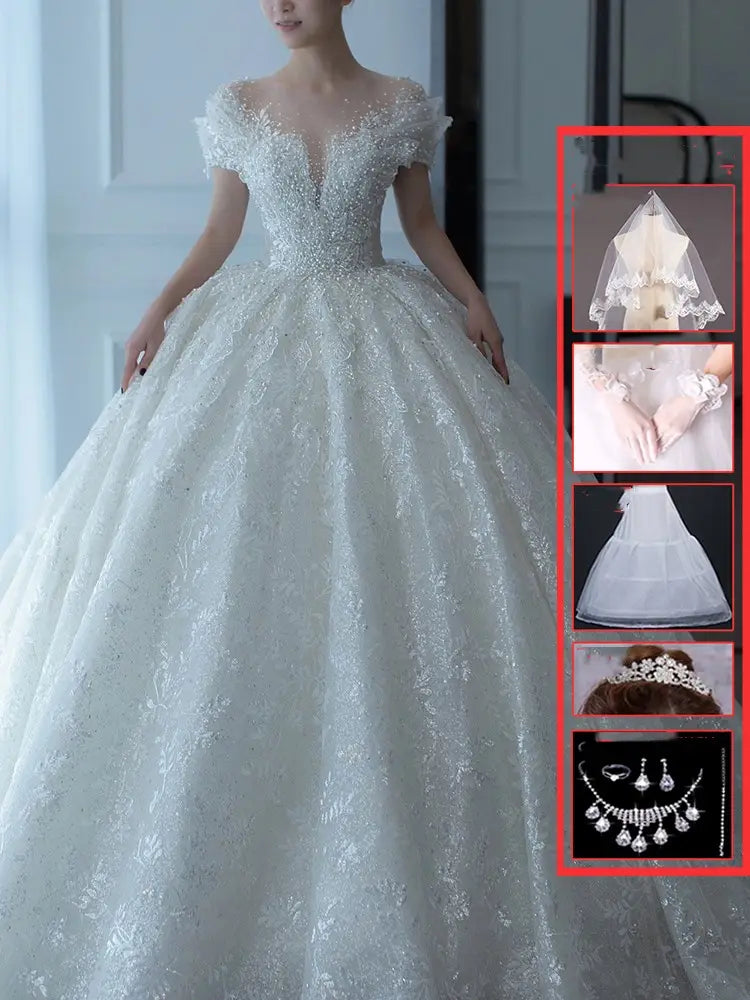 White lace wedding veil with delicate scalloped edge and sheer overlay complementing an off shoulder lace wedding dress piece set.