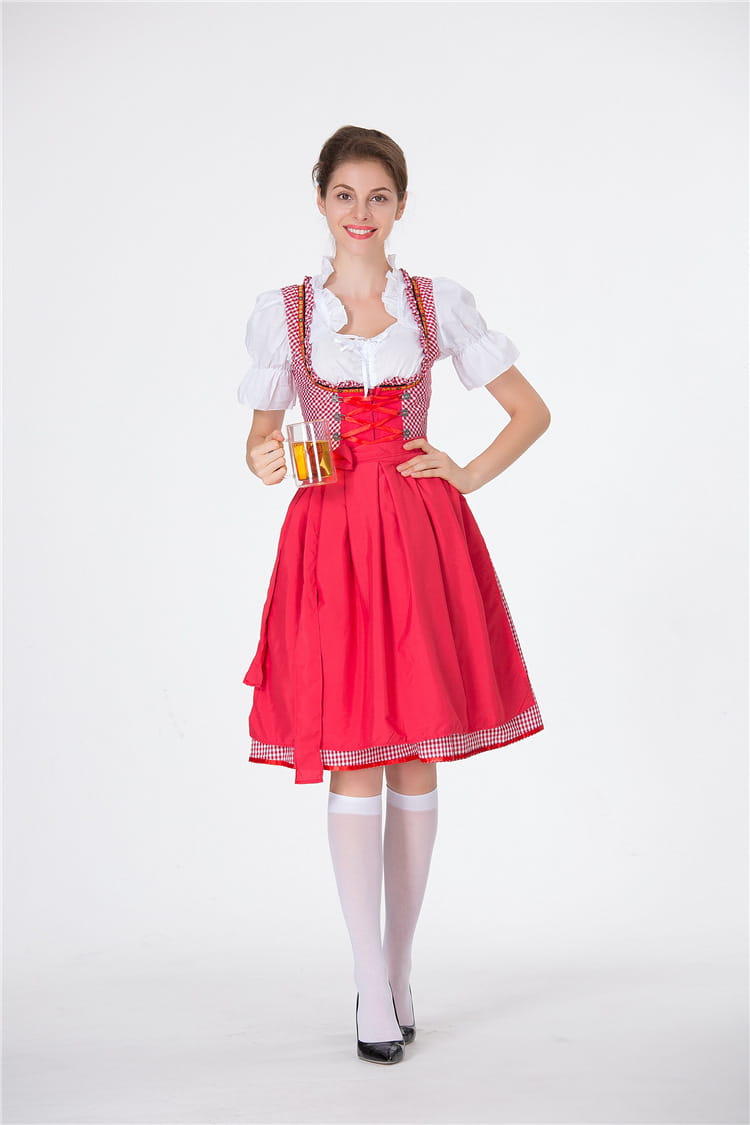 A woman wearing a traditional red and white checkered german beer festival clothing dirndl dress with puffed sleeves lace trim and a full skirt.