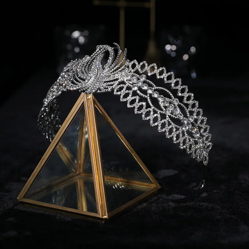 A sparkling silver rhinestone crown luxury headdress featuring intricate diamond-like embellishments and a phoenix motif, ideal for luxury clothing bridal occasions.