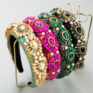 a collection of baroque vintage court style crystal headbands featuring ornate beading in vibrant gold pink and green colors
