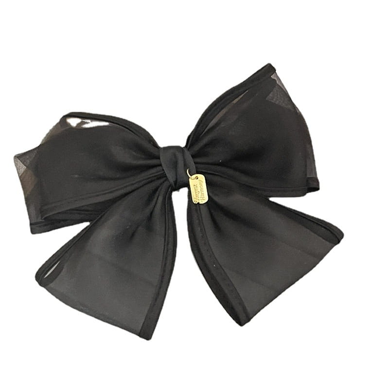 Elegant black handmade mesh bow hair clip featuring a sheer design with a gold-tone tag for women.