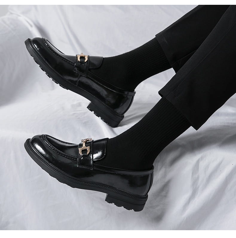 black patent horsebit loafers male featuring gold toned horsebit buckle and chunky rubber soles suitable for male fashion formal wear