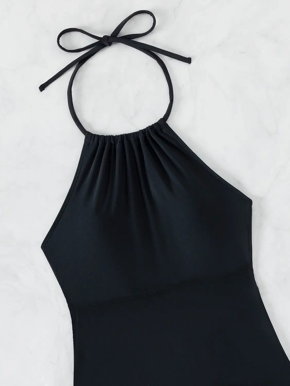 Black halterneck printed halter split swimsuit featuring a gathered neckline and tied shoulder straps.