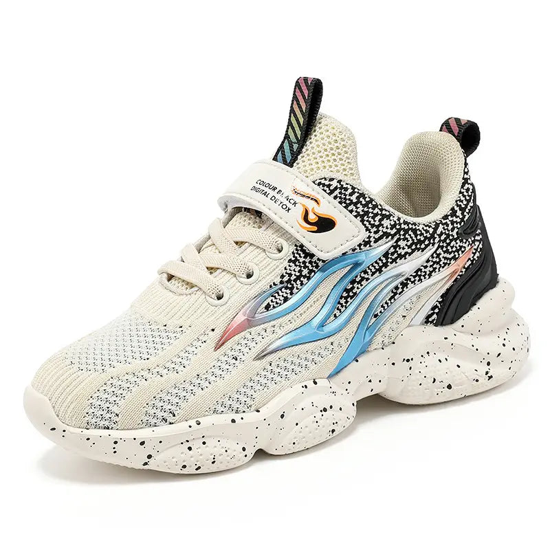 Cream-colored mesh boys sneakers fashion with black speckles, blue and pink flame design on the side, and rainbow-striped laces.