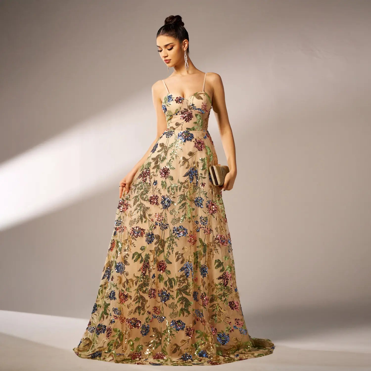 Elegant sleeveless sequined suspender evening dress featuring a beige floral embroidered gown with delicate spaghetti straps and a flowing floor-length silhouette.