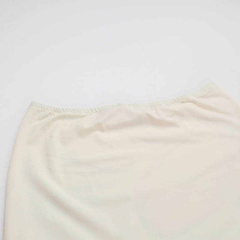 cream-colored smooth-textured fabric skirt with a gathered waistband from an elegant slim print floral top and skirt set featuring a slim print round neck design