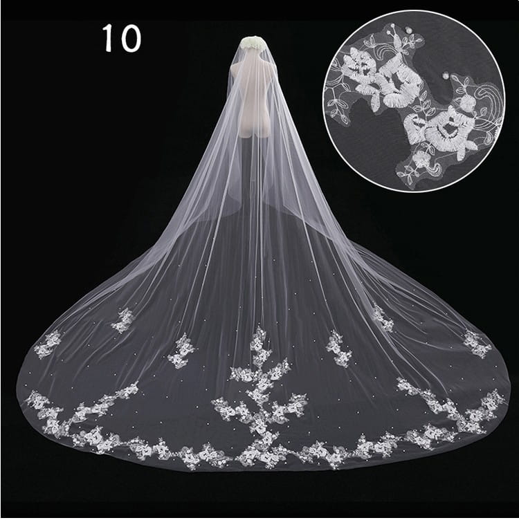 A delicate white lace wide style bridal wedding dress veil with floral embroidery, subtle beading along the hem, and an attached hair comb.