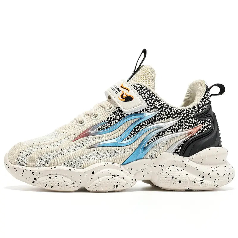Cream-colored speckled mesh boys sneakers fashion featuring a bold blue and silver flame design, black heel accent, and gold logo on the velcro strap.