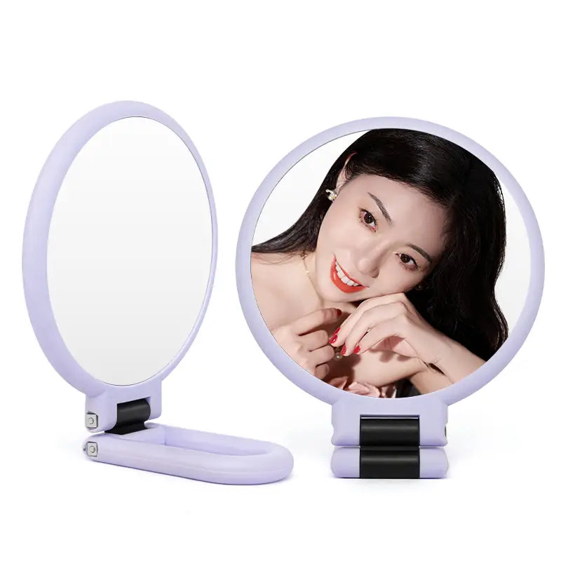 lavender-colored foldable handheld mirror with sleek minimalist design and black hinge accents featuring 10x magnification in a handle mirror purple model